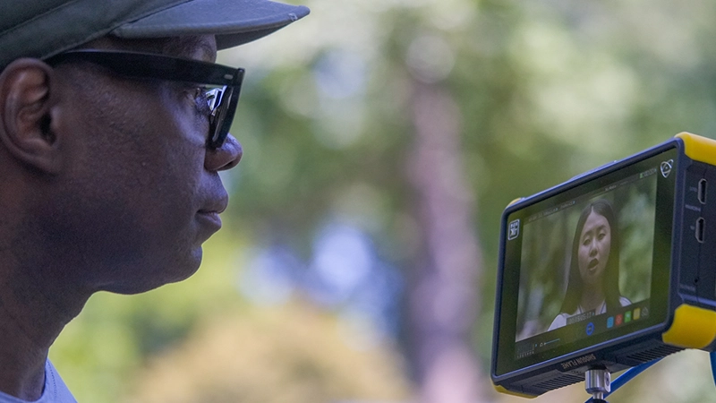Close up of man reviewing camera footage.