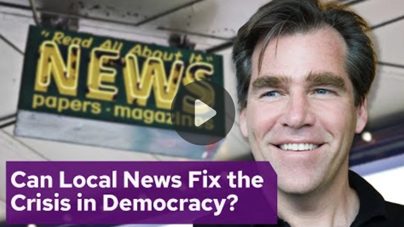 Video still of a man's face smiling behind the header "Can Local News Fix the Crisis in Democracy?"