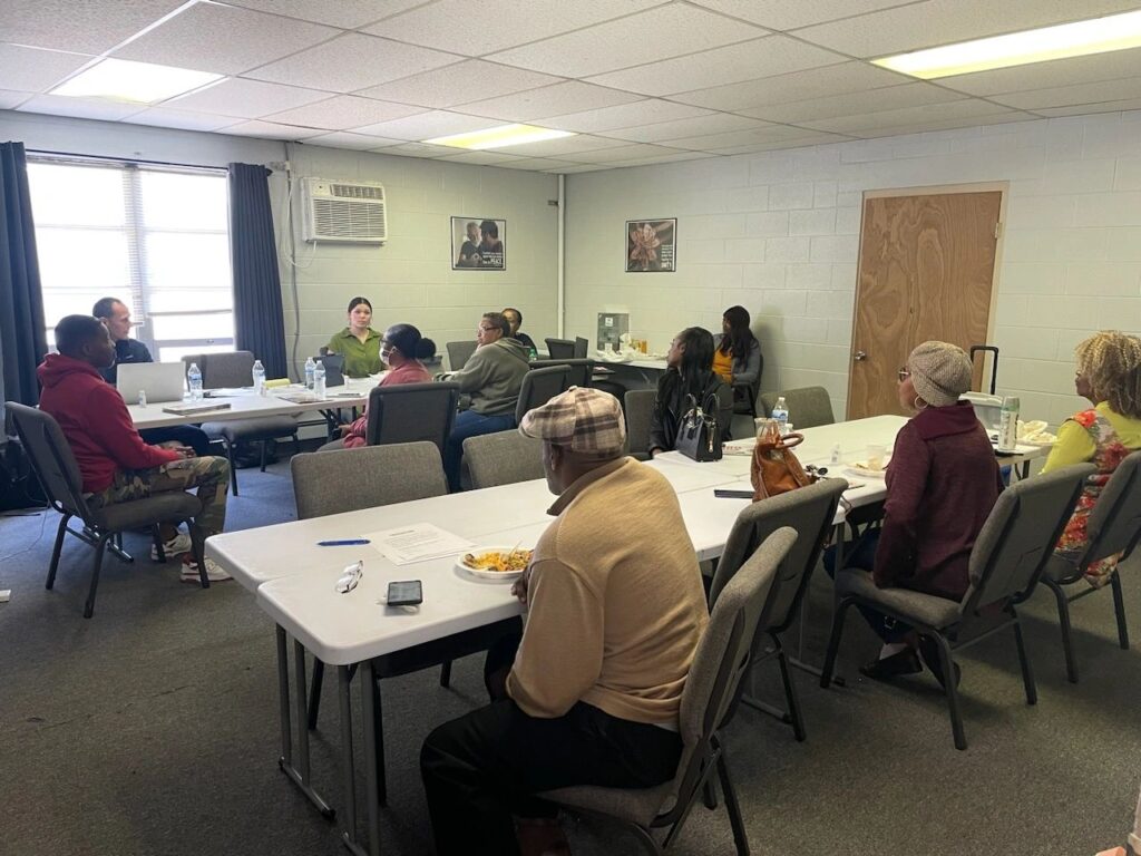 Flint residents meet with The Pivot Fund media researchers in October, discussing their media habits and calling for more local coverage. People in a conference room talking