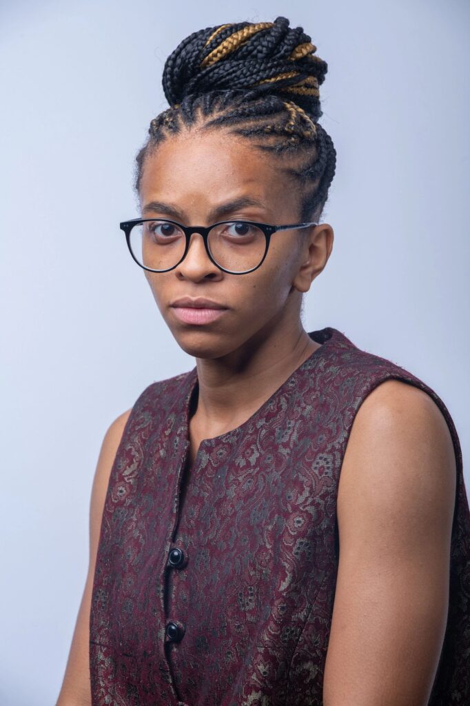 Portrait of Black woman with braids and glasses