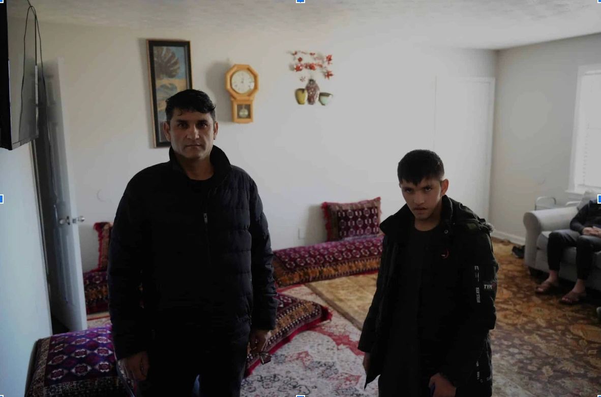 Man and boy in living room with stunned expressions.