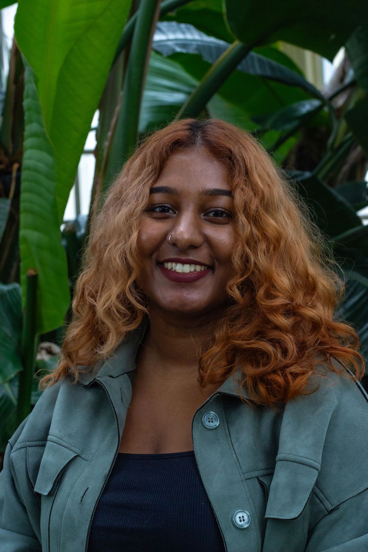 Smiling woman of color with long wavy hair