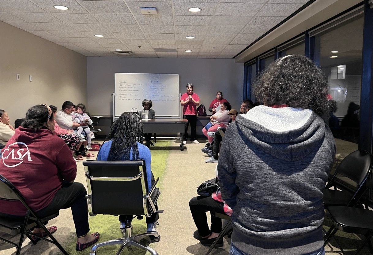 People listening to a presentation in a conference room.