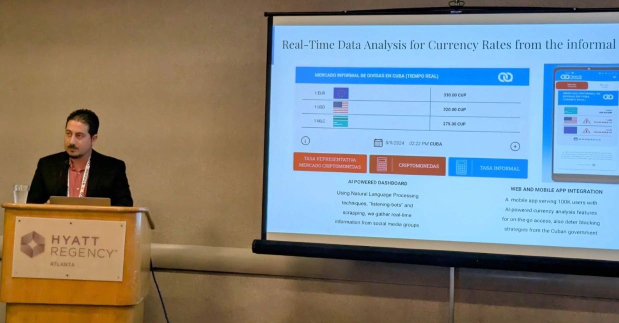 Man at podium in front of a presentation screen