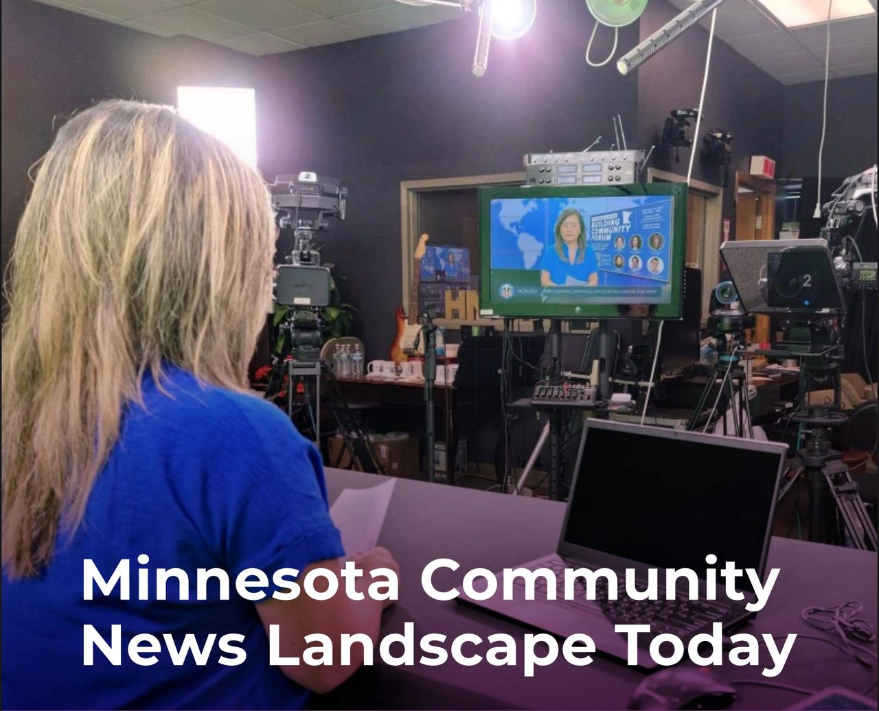 Back view of woman seated at a desk in a newsroom