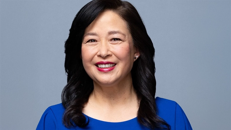 Smiling Asian woman wearing a blue blouse