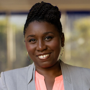 Professional Black woman in a suit smiling